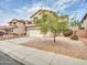 Two-story home with a balcony over the garage, desert landscaping, and a paved driveway at 3421 S 256Th Ave, Buckeye, AZ 85326