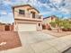 Charming two-story home features a balcony, two-car garage, and a driveway with desert landscaping at 3421 S 256Th Ave, Buckeye, AZ 85326