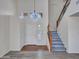 Bright foyer with a staircase, high ceilings, chandelier, and mixed flooring at 3421 S 256Th Ave, Buckeye, AZ 85326