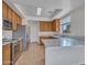 Well-lit kitchen featuring wood cabinets, stainless steel appliances, and a center island with marble countertops at 3421 S 256Th Ave, Buckeye, AZ 85326