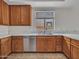 Kitchen with wood cabinets, stainless steel appliances, undermount sink, and light countertops at 3421 S 256Th Ave, Buckeye, AZ 85326