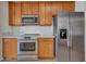 Close up of kitchen with wood cabinets, stainless steel appliances, and sleek countertop at 3421 S 256Th Ave, Buckeye, AZ 85326