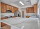 Bright kitchen features wood cabinets, stainless steel appliances, and a large quartz countertop island at 3421 S 256Th Ave, Buckeye, AZ 85326