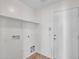 Functional laundry room with shelving, tile floor, and access to the garage at 3421 S 256Th Ave, Buckeye, AZ 85326