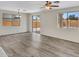 Living room area featuring wood-look flooring and a sliding glass door to the backyard at 3421 S 256Th Ave, Buckeye, AZ 85326