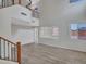 Spacious living room with hardwood floors, high ceilings, and a view of the upstairs balcony at 3421 S 256Th Ave, Buckeye, AZ 85326