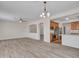 Open-concept living room showcasing laminate floors and an archway to the adjacent kitchen at 3421 S 256Th Ave, Buckeye, AZ 85326