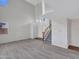 Open-concept living room with hardwood floors, abundant natural light, and staircase at 3421 S 256Th Ave, Buckeye, AZ 85326