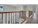 Landing features wood floors, wrought iron spindles, and natural light at 3421 S 256Th Ave, Buckeye, AZ 85326