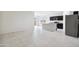 Open concept kitchen featuring tile flooring, stainless steel appliances, and bright lighting at 35566 N Breezy Ln, San Tan Valley, AZ 85140