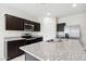 Modern kitchen features stainless steel appliances, granite countertops, and ample cabinet space at 35566 N Breezy Ln, San Tan Valley, AZ 85140