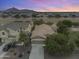 Aerial view of a home showcasing its desert neighborhood, mountain views, and well-maintained landscaping at 35624 N Zachary Rd, San Tan Valley, AZ 85144