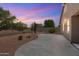 Relaxing backyard with desert landscaping and a covered patio, perfect for outdoor entertaining at 35624 N Zachary Rd, San Tan Valley, AZ 85144