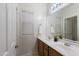 Bright bathroom featuring a double vanity, large mirror, and white cabinets for a clean, modern look at 35624 N Zachary Rd, San Tan Valley, AZ 85144