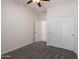 Clean bedroom featuring a ceiling fan, carpeted floor, closet with sliding doors, and a doorway entrance at 35624 N Zachary Rd, San Tan Valley, AZ 85144