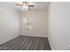 Neutral bedroom with a ceiling fan and a window offering natural light, complemented by a carpeted floor at 35624 N Zachary Rd, San Tan Valley, AZ 85144