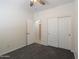 Bright bedroom featuring a ceiling fan, carpeted floor, closet with sliding doors, and a doorway entrance at 35624 N Zachary Rd, San Tan Valley, AZ 85144