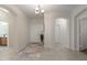 Inviting foyer with neutral tones, tile flooring, and views to a bathroom and dining room at 35624 N Zachary Rd, San Tan Valley, AZ 85144