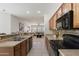 Spacious kitchen features wood cabinets, modern appliances, and breakfast bar at 35624 N Zachary Rd, San Tan Valley, AZ 85144