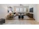 Bright living room featuring stylish sofas, decor, shutters and a ceiling fan at 35624 N Zachary Rd, San Tan Valley, AZ 85144