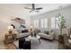 Bright living room featuring stylish sofas, decor, shutters and a ceiling fan at 35624 N Zachary Rd, San Tan Valley, AZ 85144