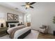 Main bedroom with a ceiling fan, ensuite bathroom, and neutral decor at 35624 N Zachary Rd, San Tan Valley, AZ 85144