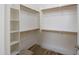 Walk-in closet with built-in shelving and wooden rods for optimal organization at 35624 N Zachary Rd, San Tan Valley, AZ 85144