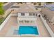 Aerial view of a home featuring a backyard pool with concrete surround, a patio, and green landscaping at 3841 E Esplanade Ave, Gilbert, AZ 85297