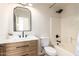 Stylish bathroom with modern fixtures, a vanity with drawers, and a shower-tub combo, offering a serene space at 3841 E Esplanade Ave, Gilbert, AZ 85297