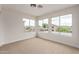 Sunlit bedroom with multiple windows offering neighborhood views and neutral carpeting, ready for personal touches at 3841 E Esplanade Ave, Gilbert, AZ 85297