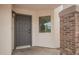 Inviting front door and entryway of home featuring brick detail and a window to the interior stairway at 3841 E Esplanade Ave, Gilbert, AZ 85297
