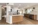 Spacious kitchen boasts white and wood cabinetry, quartz countertops, stainless steel appliances, and a large island at 3841 E Esplanade Ave, Gilbert, AZ 85297