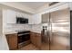 Modern kitchen featuring stainless steel appliances, white cabinetry, and stylish backsplash for a contemporary look at 3841 E Esplanade Ave, Gilbert, AZ 85297