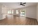 Spacious living room with ample natural light, fan, and a seamless transition to the outdoor pool area at 3841 E Esplanade Ave, Gilbert, AZ 85297