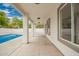 Covered patio with a view of the pool, featuring concrete flooring, white columns, and recessed lighting at 3841 E Esplanade Ave, Gilbert, AZ 85297