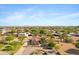 This view showcases a charming single-story home with mature landscaping, long driveway, and tile roof at 4187 E Triple Crown Dr, San Tan Valley, AZ 85140