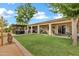 Landscaped backyard with mature trees, a pergola, and an outdoor seating area at 4187 E Triple Crown Dr, San Tan Valley, AZ 85140