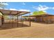 Horse property showcasing outdoor stalls, metal roofing, and ample space for animals at 4187 E Triple Crown Dr, San Tan Valley, AZ 85140