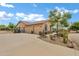This property features an oversized three car garage, water fountain, and mature desert landscaping at 4187 E Triple Crown Dr, San Tan Valley, AZ 85140