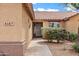Inviting front entrance features a tiled roof, a well-maintained facade, and beautiful landscaping at 4187 E Triple Crown Dr, San Tan Valley, AZ 85140