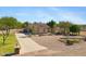 This view shows a charming single-story home with desert landscaping, a circular driveway, and a tile roof at 4187 E Triple Crown Dr, San Tan Valley, AZ 85140