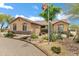Landscaped desert front yard with a bridge, mature trees, and an American flag at 4187 E Triple Crown Dr, San Tan Valley, AZ 85140