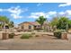 Charming single-story home featuring a circular driveway, desert landscaping, and a tiled roof at 4187 E Triple Crown Dr, San Tan Valley, AZ 85140