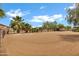 Wide shot of a horse arena in the front yard with a home and corrals visible in the background at 4187 E Triple Crown Dr, San Tan Valley, AZ 85140