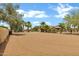 Expansive front yard with mature trees, a horse arena, and a glimpse of the charming home at 4187 E Triple Crown Dr, San Tan Valley, AZ 85140