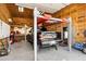 Car lift installed in the garage to accommodate a car on top of a truck, pegboard wall, and epoxy floors at 4187 E Triple Crown Dr, San Tan Valley, AZ 85140