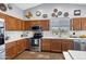 A kitchen featuring wood cabinets, stainless steel appliances, white countertops, and tile backsplash, with decorative wall art at 4187 E Triple Crown Dr, San Tan Valley, AZ 85140