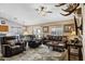 Inviting living room boasts comfortable leather seating, a ceiling fan, and an open floor plan at 4187 E Triple Crown Dr, San Tan Valley, AZ 85140