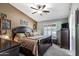 Spacious bedroom with ceiling fan, natural light, and dark wood furniture at 4187 E Triple Crown Dr, San Tan Valley, AZ 85140