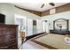Comfortable bedroom featuring dark wood furniture and views into the main bathroom at 4187 E Triple Crown Dr, San Tan Valley, AZ 85140